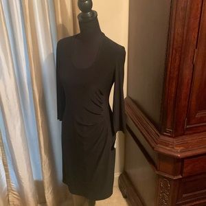 Black dress . Side of dress is cinched in a crescent shape . Very flattering